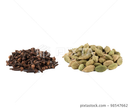 Culinary seasonings cardamom and cloves on a white background. 98547662