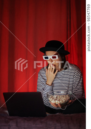 woman and labrador dog watch movie at home with glasses, hat and eat popcorn woman and labrador dog watch movie at home with glasses, hat and eat popcorn 98547769