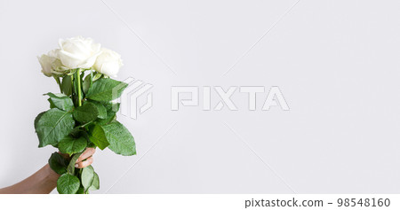 Bouquet of white roses flower in female hand. Greeting card. Bouquet of white roses flower in female hand. Greeting card. 98548160