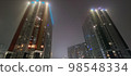 colored apartment buildings in the fog in night 98548334
