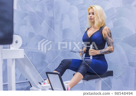 Athletic young woman working out on fitness exercise equipment 98548494