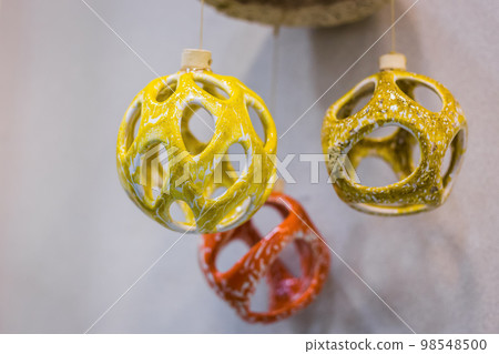 Unusual ceramic hanging decor on earthenware exhibition - close up Unusual ceramic hanging decor on earthenware exhibition - close up 98548500