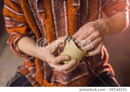 Professional male potter working in workshop, studio 98548501