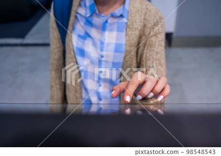 Woman using interactive touchscreen display at modern museum or exhibition 98548543