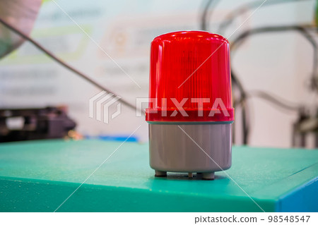 Close up of warning red beacon flashing on table Close up of warning red beacon flashing on table 98548547