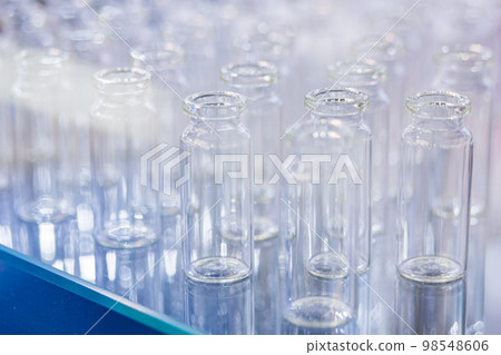 Medical empty glass bottles in showcase at pharmaceutical exhibition Medical empty glass bottles in showcase at pharmaceutical exhibition 98548606