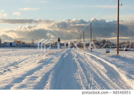 Country road after a snowstorm covered with snow Country road after a snowstorm covered with snow 98548951