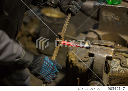 Blacksmith working with metal Blacksmith working with metal 98549147