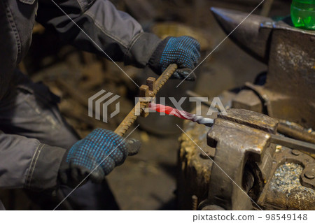 Blacksmith working with metal Blacksmith working with metal 98549148