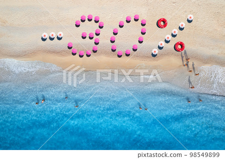Creative text -30 made from umbrellas on sandy beach, blue sea Creative text -30 made from umbrellas on sandy beach, blue sea 98549899