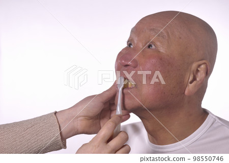 brushing the teeth of an old man in nursing care 98550746