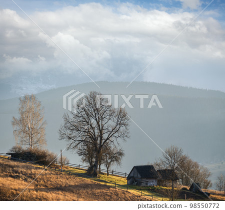 Last good weather days in autumn mountain countryside. Peaceful picturesque Ukrainian Carpathians mountains scene. 98550772