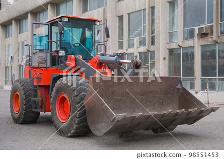 Red Heavy Power Bulldozer work on a building site 98551453