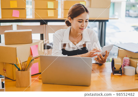 Small business owners online are chatting, selling products and checking orders for products that customers order. of online retailers - online shopping Small business owners online are chatting, selling products and checking orders for products that customers order. of online retailers - online shopping 98552482