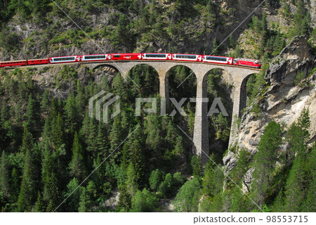 A Rhaetian Bahn train crossing the Landwasser Viaduct 98553715