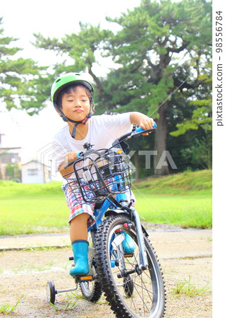 child riding a bicycle 98556784