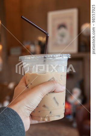 Woman hold her iced coffee 98557025