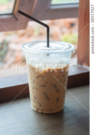 Iced coffee on wooden table Iced coffee on wooden table 98557027