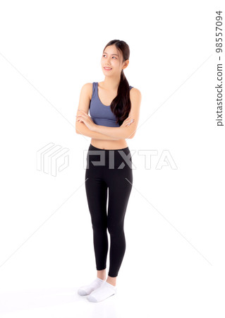 Portrait of beautiful young asian woman in sportwear smile and crossed arms isolated. 98557094