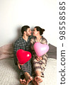 Couple of lovers holds balloons in the shape of a heart. The concept of Valentine's Day. Front view. 98558585