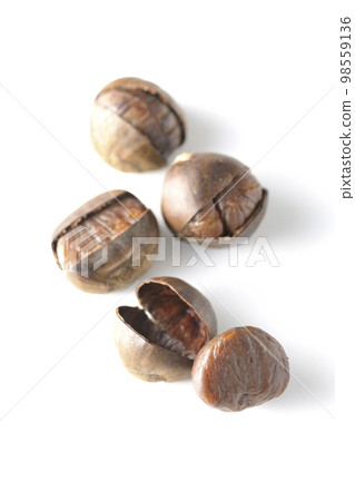 Photographing sweet chestnuts against a white background 98559136