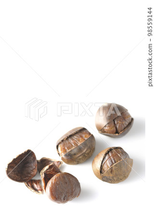 Photographing sweet chestnuts against a white background 98559144