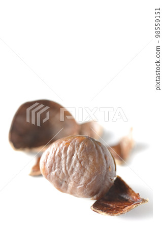 Photographing sweet chestnuts against a white background 98559151