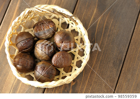 sweet chestnuts in a bamboo basket sweet chestnuts in a bamboo basket 98559359
