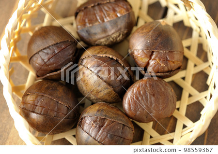 sweet chestnuts in a bamboo basket sweet chestnuts in a bamboo basket 98559367