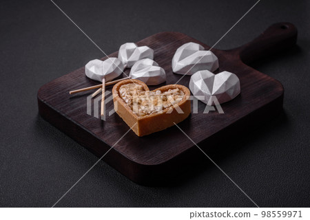 Beautiful tasty sweet candies in gray color on a dark concrete background 98559971