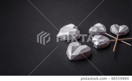 Beautiful tasty sweet candies in gray color on a dark concrete background Beautiful tasty sweet candies in gray color on a dark concrete background 98559984