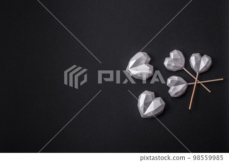 Beautiful tasty sweet candies in gray color on a dark concrete background Beautiful tasty sweet candies in gray color on a dark concrete background 98559985