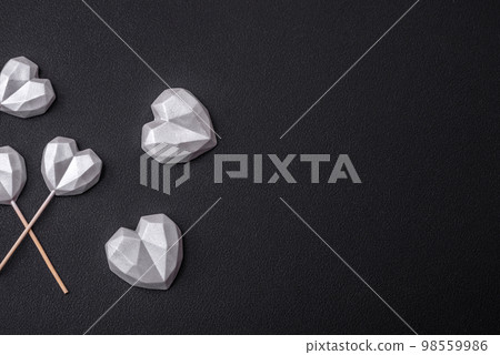 Beautiful tasty sweet candies in gray color on a dark concrete background Beautiful tasty sweet candies in gray color on a dark concrete background 98559986