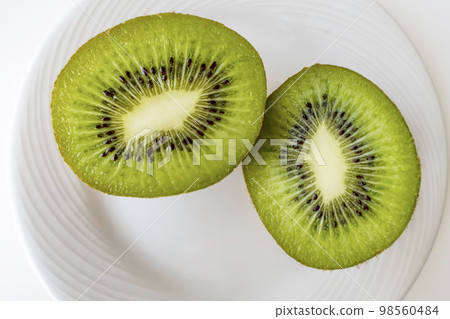 sliced kiwi fruits on white plate sliced kiwi fruits on white plate 98560484