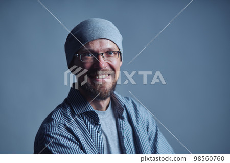 Cheerful man with glasses smiling at camera Cheerful man with glasses smiling at camera 98560760