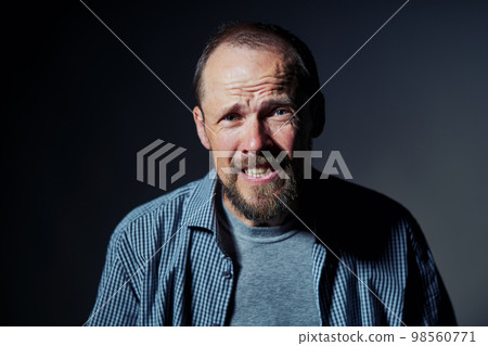 Portrait of mature man with confused expression Portrait of mature man with confused expression 98560771