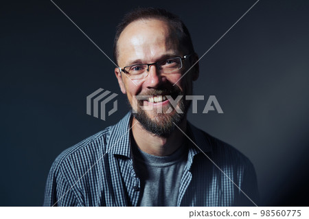 Cheerful man with glasses smiling at camera 98560775