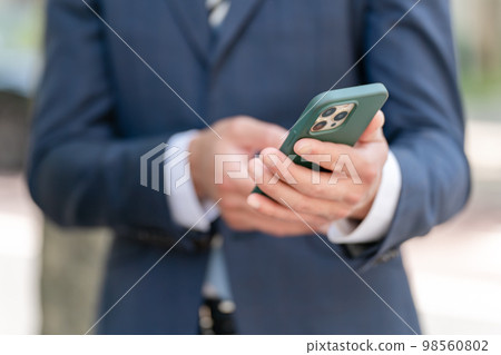Businessman smartphone hand Businessman smartphone hand 98560802