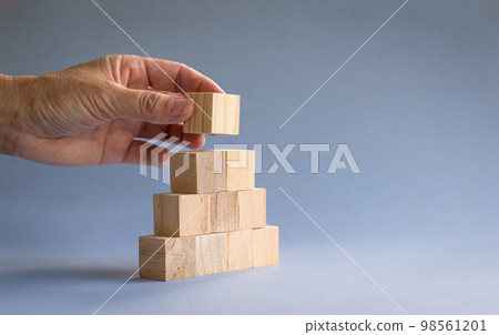 Hand stacking wood blocks. Hand stacking wood blocks. 98561201