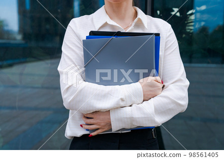 Business caucasian woman holding paper folder file smiling and feeling Business caucasian woman holding paper folder file smiling and feeling 98561405