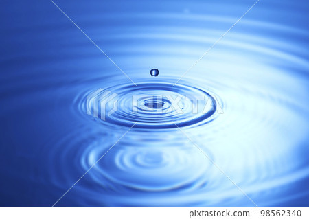water drops falling into deep blue water water drops falling into deep blue water 98562340