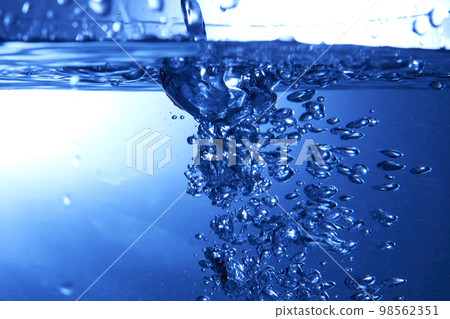 water drops falling into deep blue water water drops falling into deep blue water 98562351