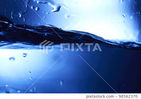 water drops falling into deep blue water water drops falling into deep blue water 98562370