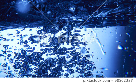 water drops falling into deep blue water water drops falling into deep blue water 98562387