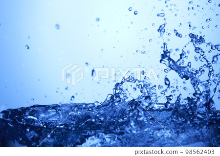 water drops falling into deep blue water water drops falling into deep blue water 98562403