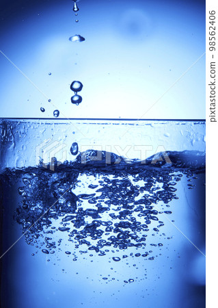 water drops falling into deep blue water water drops falling into deep blue water 98562406