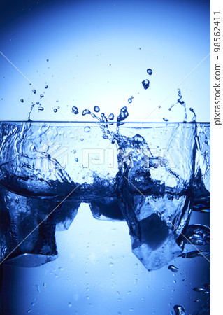 water drops falling into deep blue water water drops falling into deep blue water 98562411
