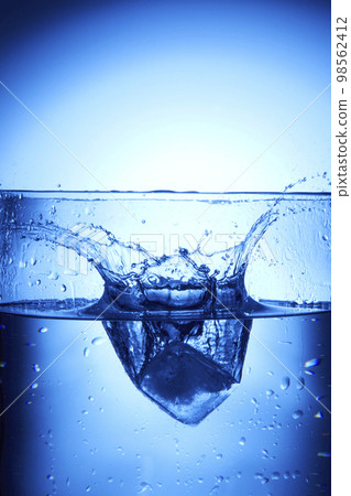 water drops falling into deep blue water water drops falling into deep blue water 98562412