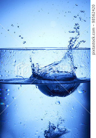 water drops falling into deep blue water 98562420