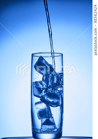 water drops falling into deep blue water water drops falling into deep blue water 98562424